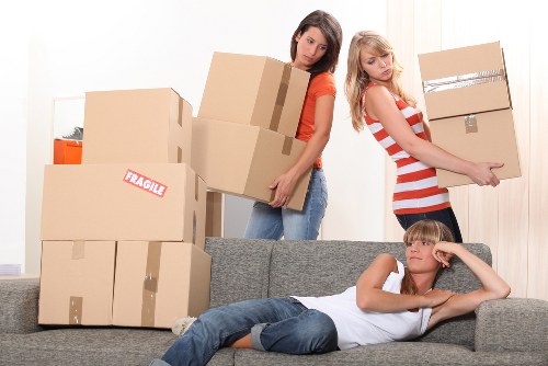 Professional movers loading furniture into a removal van